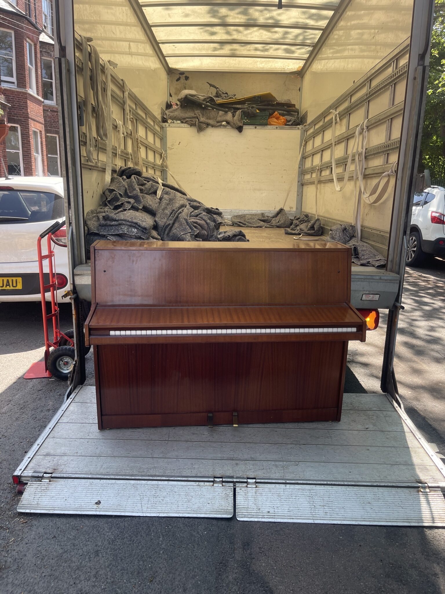 Large piano being moved safely during a Brighton house move